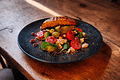 Oven-roasted salmon recipe served on a Mediterranean mixed leaf salad with lemon pepper and red pepper powder. Perfect for a light and healthy lunch or dinner.